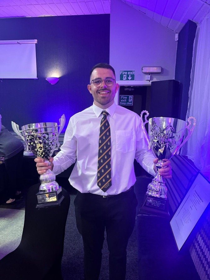 Ellis holding two Player of the Year trophies for Beddau RFC